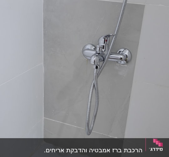 התקנת סוללת אמבטיה וצינור מקלחון בחדר רחצה